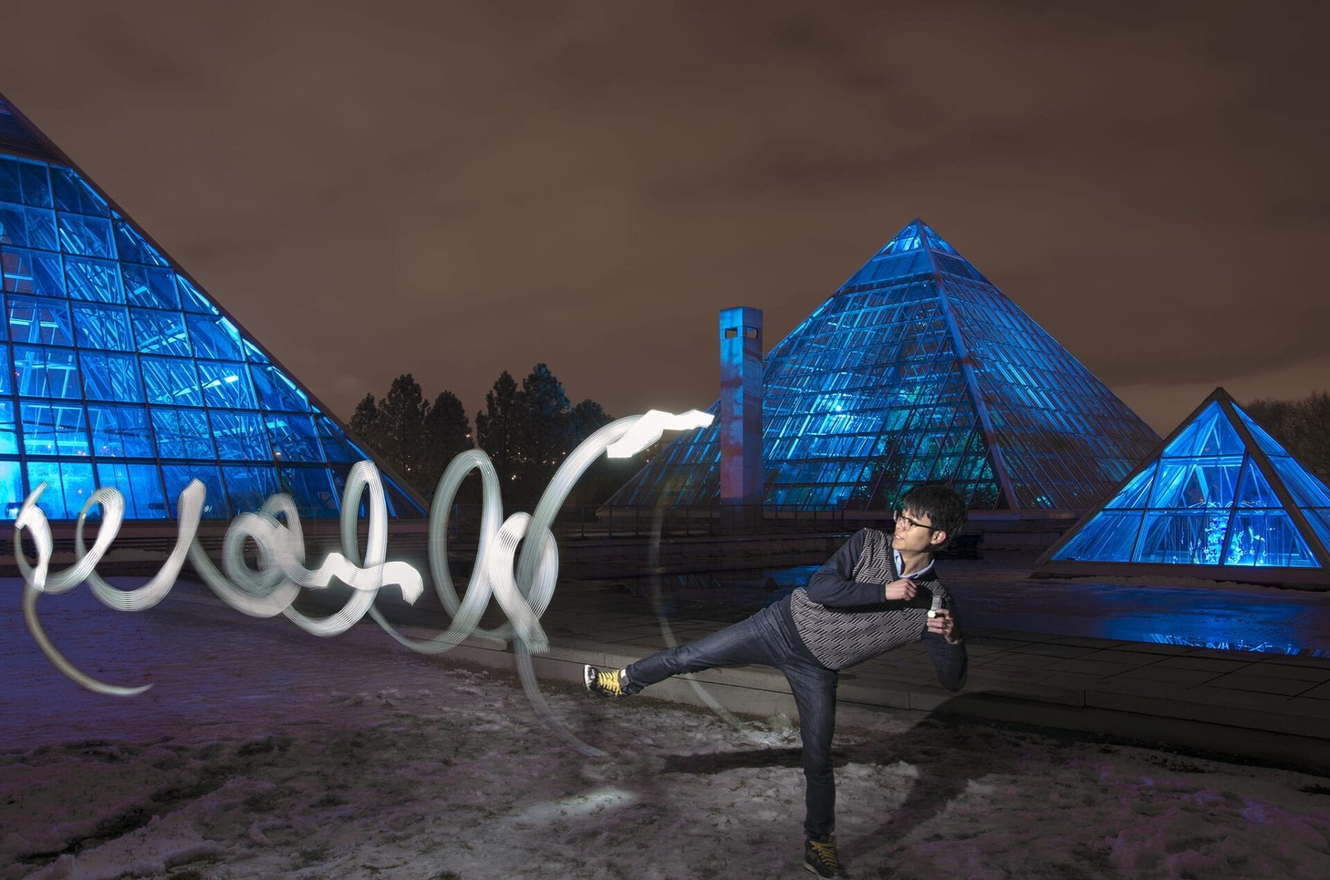 mpStudio phtographer makes a kung fu pose for his light painting photo